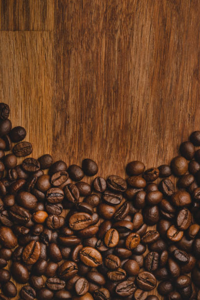 istock Coffee beans roasted on wooden background Close up macro copy space 1366137727