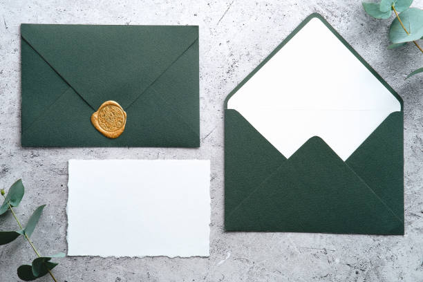 istock Wedding stationery set. Green envelopes and blank paper card on concrete table with eucalyptus branches. 1366137765