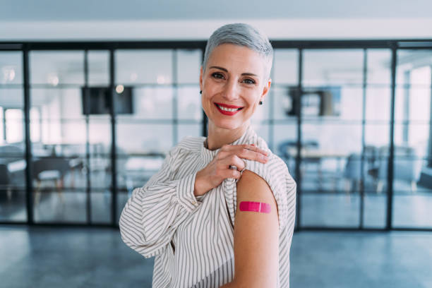 istock Woman showing her shoulder after getting vaccinated. 1366137788