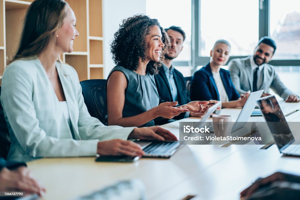 Business persons on meeting in the office. Group of business persons in business meeting. Group of entrepreneurs on meeting in board room. Corporate business team on meeting in the office. Business Stock Photo
