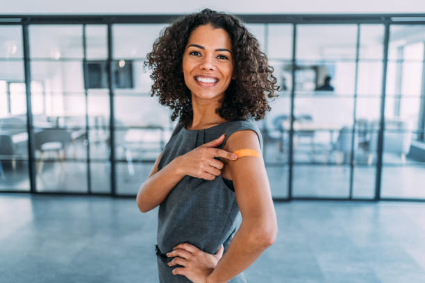Woman showing her shoulder after getting vaccinated.