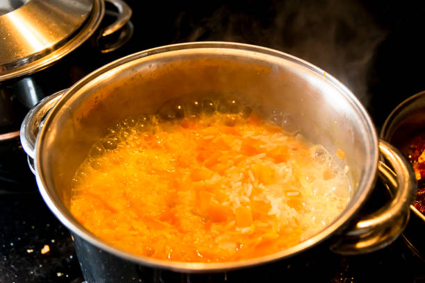 istock White brown rice cooking in the pan in a kitchen. 1366139076
