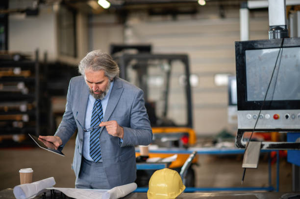 istock Mature engineer. Quality inspector. Mature male engineer in production 1366139099