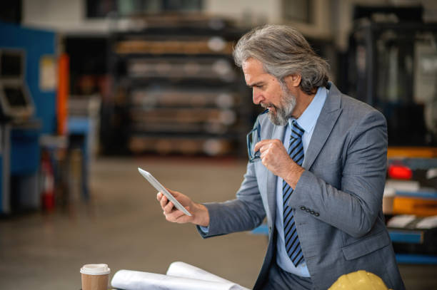 istock Senior engineer in a factory 1366140236