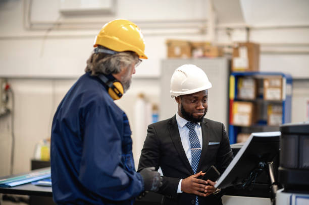 istock Supervisor and worker discussing in factory 1366142027