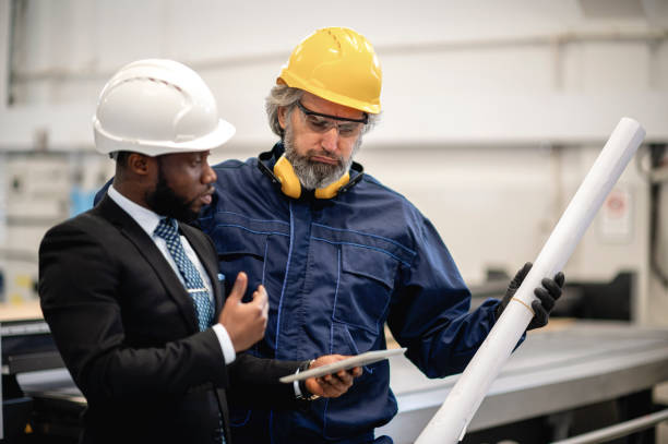 istock Supervisor and worker discussing in factory 1366142780