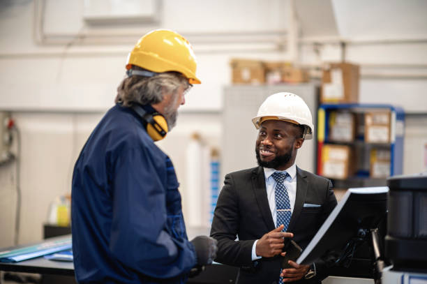 istock Supervisor and worker discussing in factory 1366143235