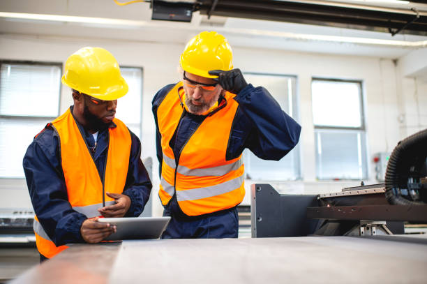 istock Multi-ethnic workers in factory inspecting product 1366145291