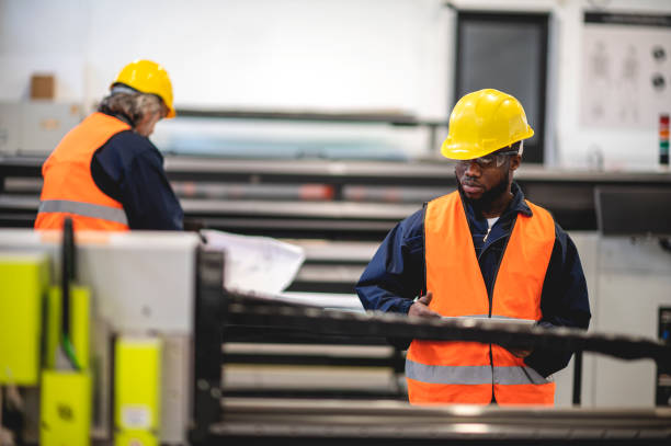 istock Two workers at an industrial plant. working together manufacturing activities 1366145555