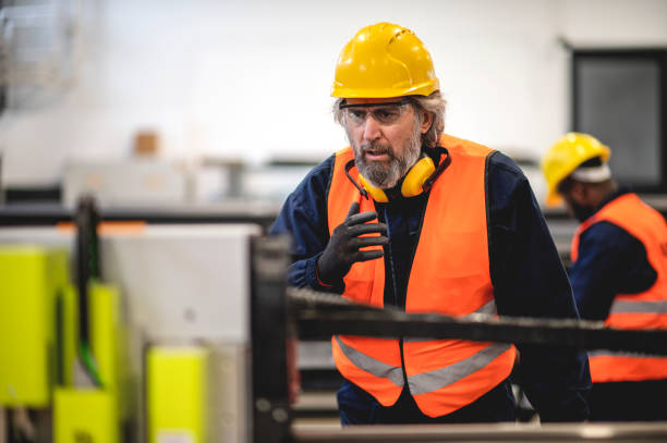 istock Two workers at an industrial plant. working together manufacturing activities 1366146092