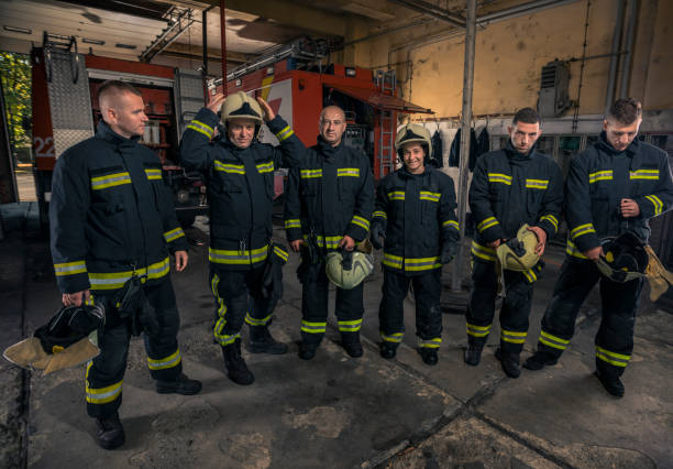 istock Portrait of firefighters standing by a fire engine. 1366150782