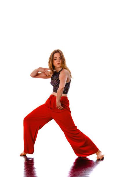 Modern teenage girl dancer dancing hip-hop isolated on a white background
