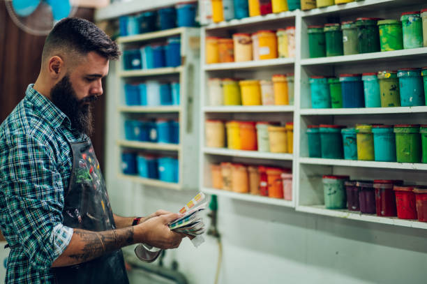 istock Male worker mixing colors for screen printing in a workshop 1366158070