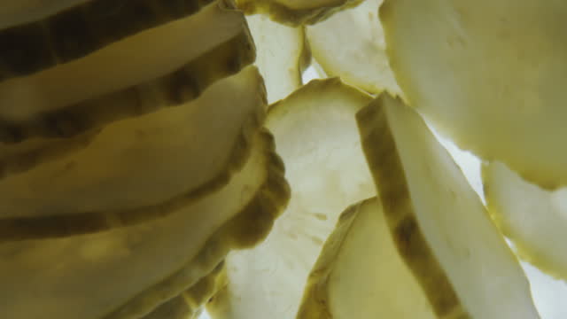 Dill Pickle Slices Swirling in Water