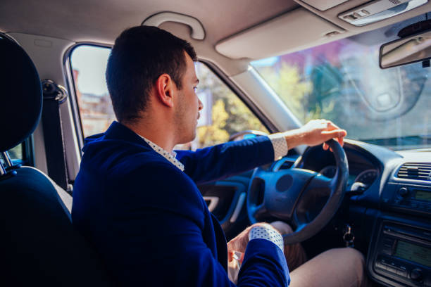 istock Reckless businessman driving in the city during the rush hour while doing corporate work on his tablet. 1366159886