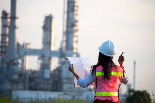 istock Manager in safety helmets working with documents at factory. 1366170564
