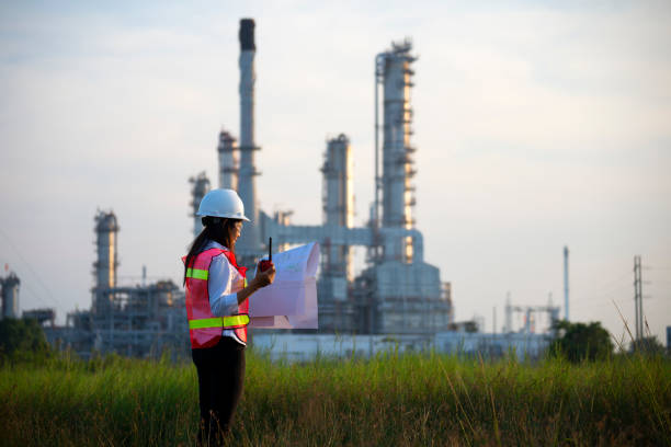 istock Manager in safety helmets working with documents at factory. 1366170565