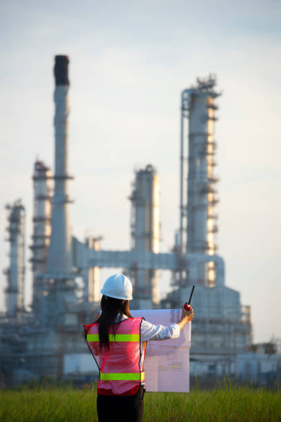 istock Manager in safety helmets working with documents at factory. 1366170568