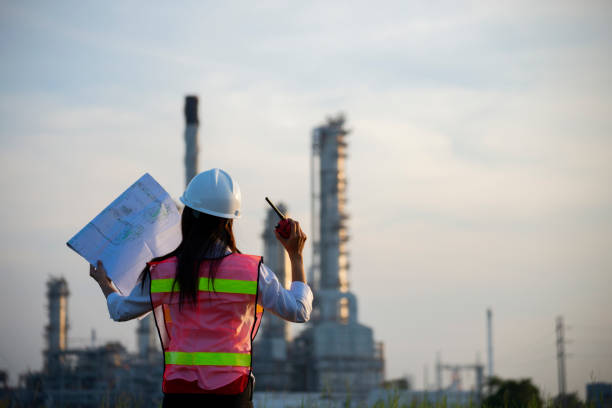 istock Manager in safety helmets working with documents at factory. 1366170778