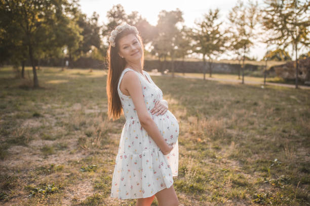 istock Smiling future mother in the park 1366174261