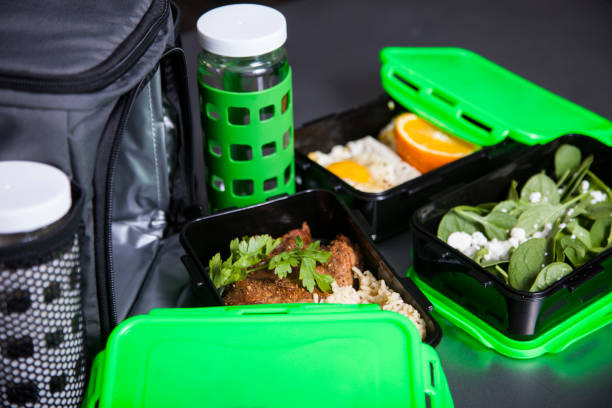 Green Tupperware food containers with meal prep food inside stock photo