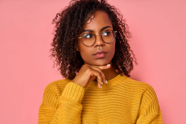 istock Young African American woman with thoughtful expression, thinks about the question, feels doubt 1366180169