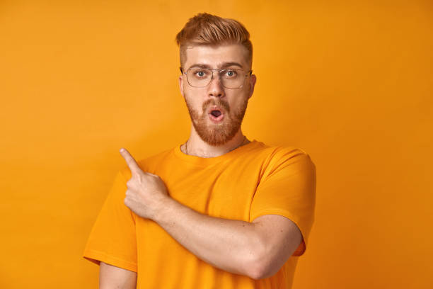 istock Surprised male with red beard, being stupefied as advertises something 1366180212
