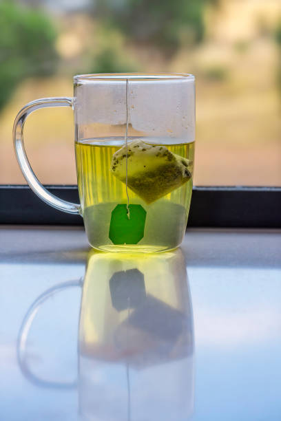 istock Cup of green tea brewing 1366181138
