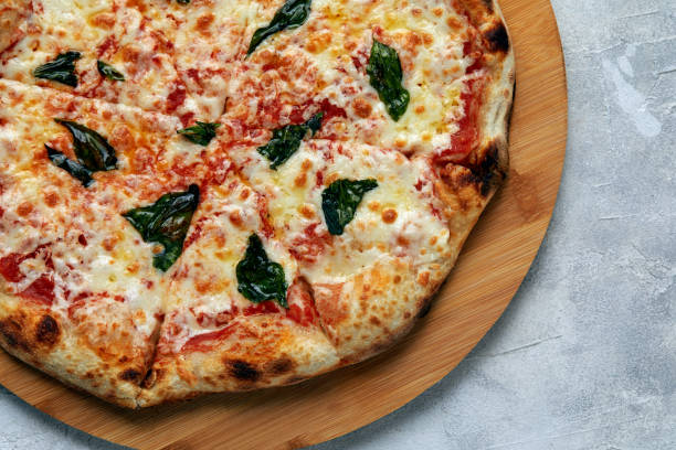 istock Whole neapolitan pizza served on wooden board 1366183829