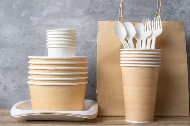 istock Eco friendly food packaging on table background. natural container: cup, plate, spoon and fork. zero waste, pollution, earth day, free plastic, world Environment day concept 1366188313