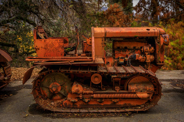 viejo equipo pesado abandonado, tractor de banda de rodadura, entre árboles en un entorno rural - heavy dirty bad condition old fashioned fotografías e imágenes de stock