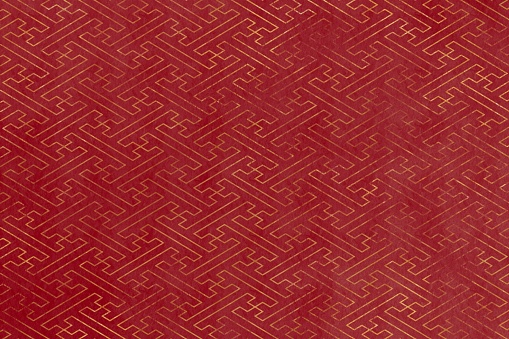 Red abstract background with golden swastika(Sayagata). Japanese traditional geometric pattern. Japanese paper style texture