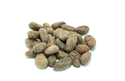 Raw cocoa beans isolated on white background.