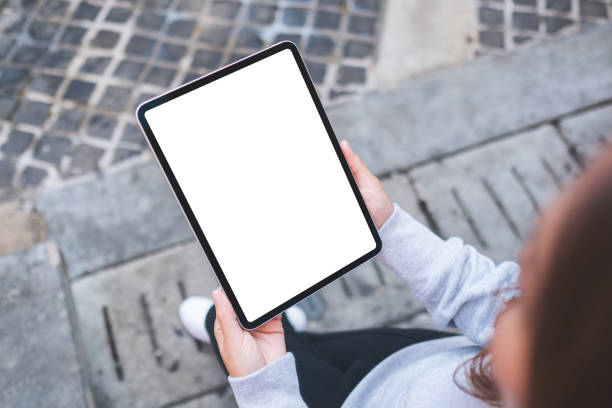 istock Top view mockup image of a woman holding digital tablet with blank white desktop screen 1366191124