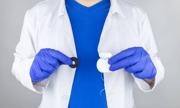 istock Dental floss close up. Dentist shows how to use the thread correctly. Different types of flossing. The concept of proper oral care. Selective focus. 1366192001
