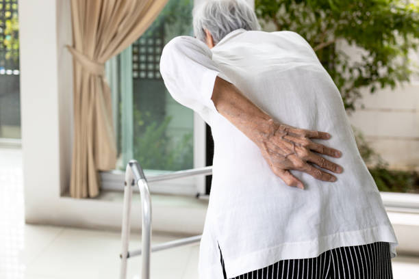 hand of asian old elderly touch lower back muscles,senior patient with walker stick,suffering from back pain,backache from spinal joint problems,myositis,painful of lumbago,health care,medical concept"n - lower back pain imagens e fotografias de stock