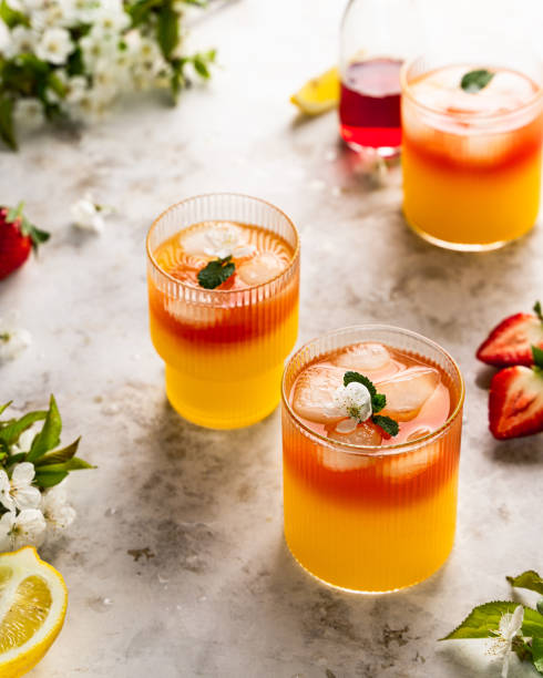 istock Pink strawberry lemonade with lemon, lime, oranges and strawberries on white background. 1366195110