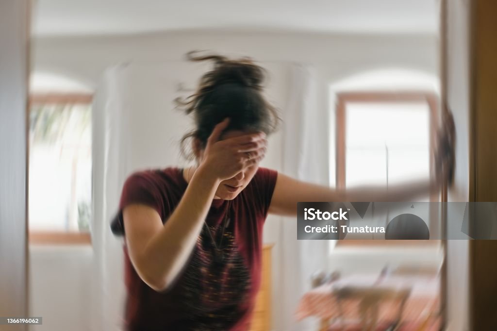 Blurred photo of woman suffering from vertigo or dizziness or other health problem of brain or inner ear. Woman suffering from vertigo or dizziness or other health problem of brain or inner ear. Dizzy Stock Photo