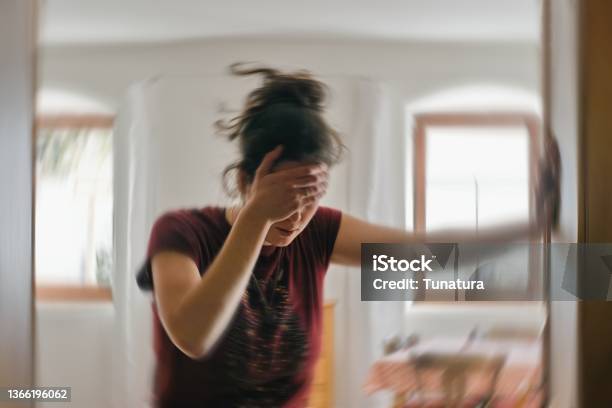 Blurred Photo Of Woman Suffering From Vertigo Or Dizziness Or Other Health Problem Of Brain Or Inner Ear Stock Photo - Download Image Now