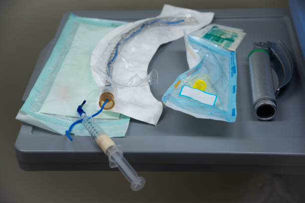endotracheal tube, syringe and laryngoscope for general anesthesia on the table - general group of objects healthcare and medicine patient imagens e fotografias de stock