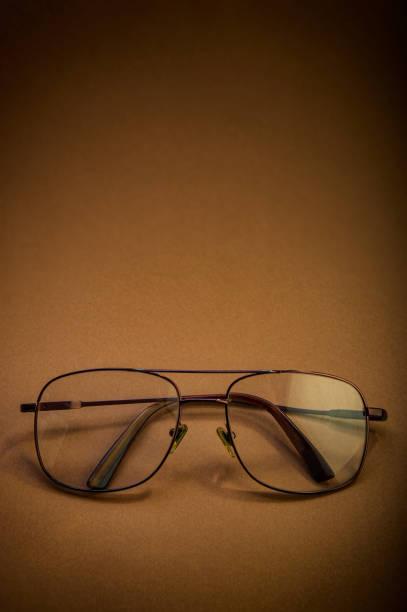 istock Glasses with transparent glasses lie on a brown background. 1366197098
