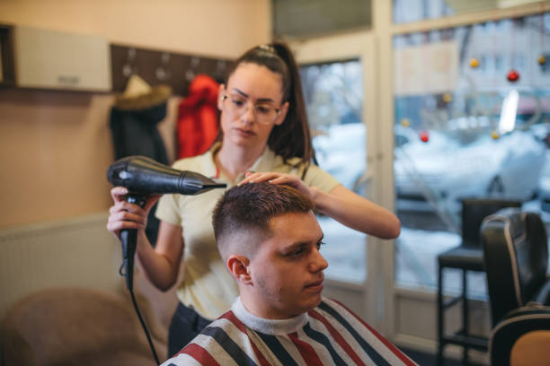 istock A young hairdresser blows a man 1366199236