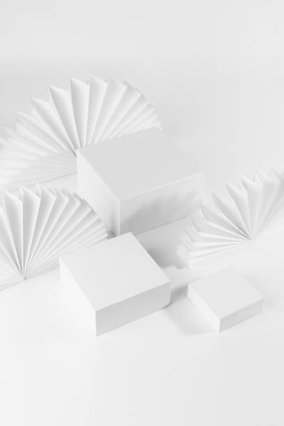 istock White abstract scene for presentation cosmetic produce, goods, advertising, design with three square podiums on table, chinese paper fans as decor, top view, corner, 3d, vertical. 1366202119