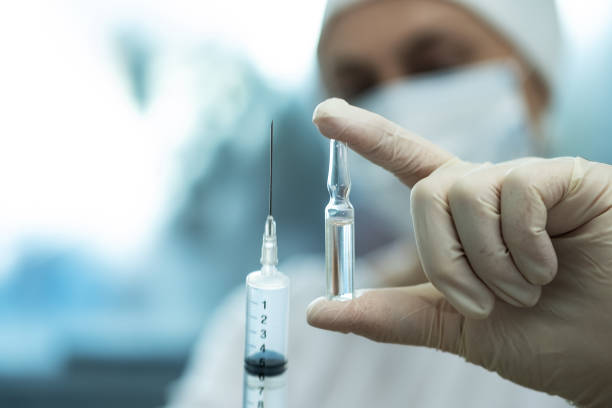 istock Ampoule and syringe in the doctor's hand. 1366204468