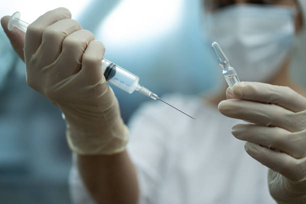 istock Ampoule and syringe in the doctor's hand. 1366204512