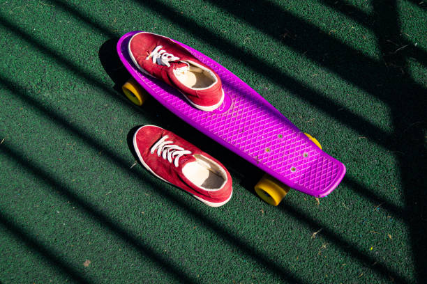 istock red sneakers on a pink skateboard 1366204668