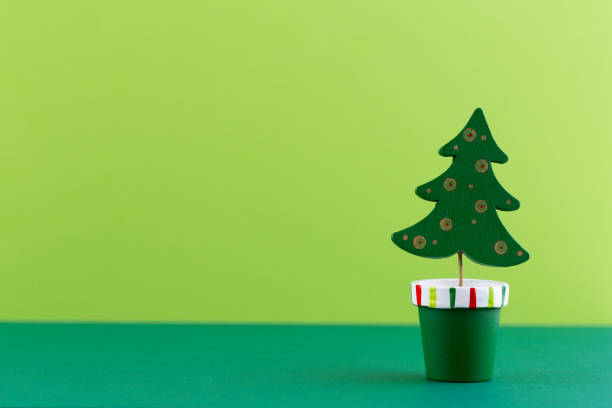 istock Christmas tree on pastel colored background. Christmas or New Year minimal concept. 1366205962