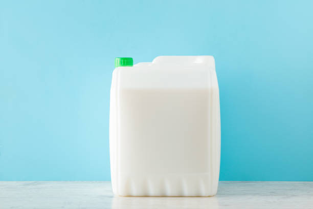 istock 10 L white plastic container on light table at blue wall background. Pastel color. Repair work primer, cleaning detergent, washing liquid or body care product. Empty place for text on can. Front view. 1366206241