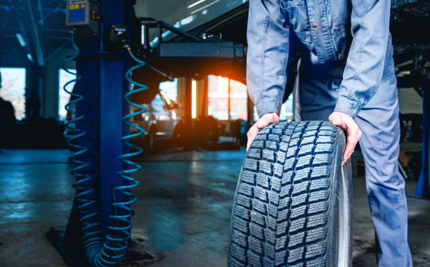 Seasonal tire changeover in auto service. Tire swap background with copy space. Winter tire storage. stock photo