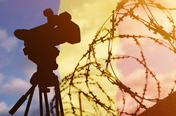 istock Double exposure - camera, barbed wire and flag Romania 1366206551